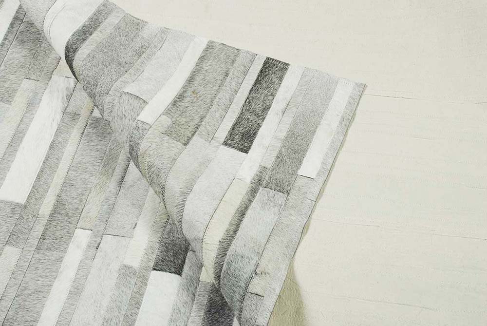 Full cotton backing on a custom white patchwork cowhide rug in Stripes