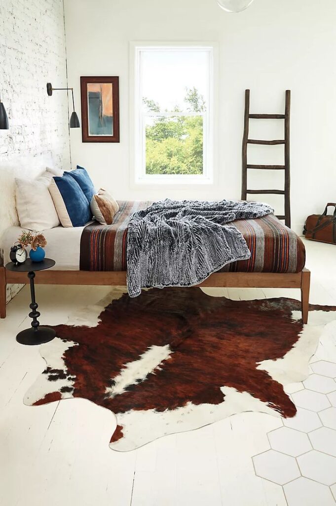Accent piece cowhide rug in bedroom