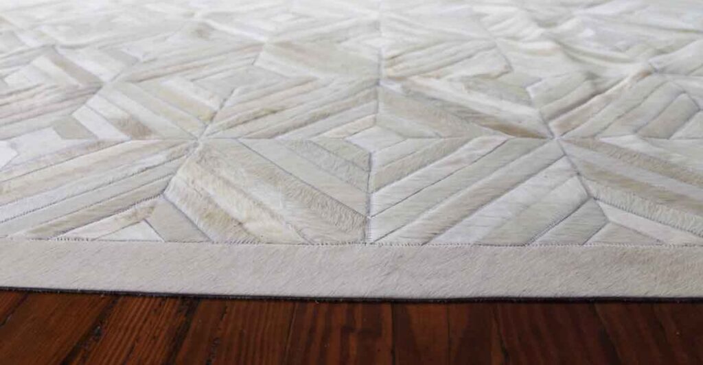 Flat and relaxed white Diamond patchwork cowhide rug