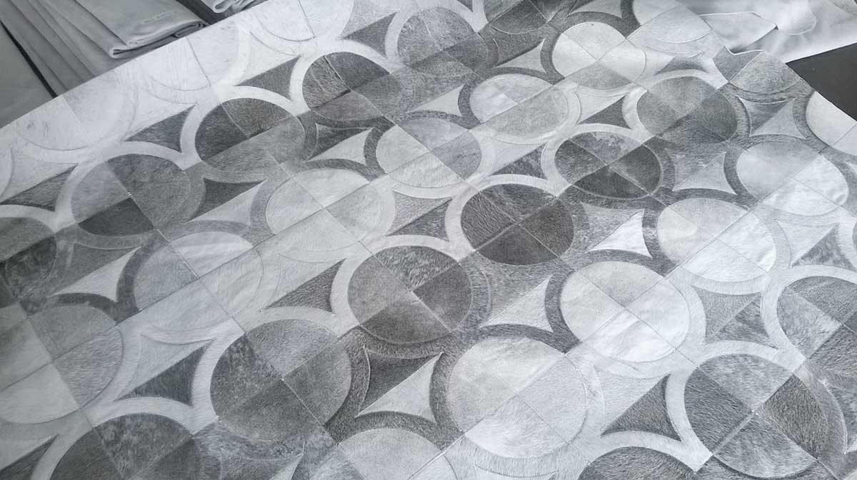 Custom patchwork cowhide rug in gray circles