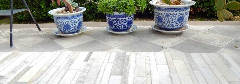 White and gray patchwork cowhide rug in Stripes, design No. 252 on a terrace