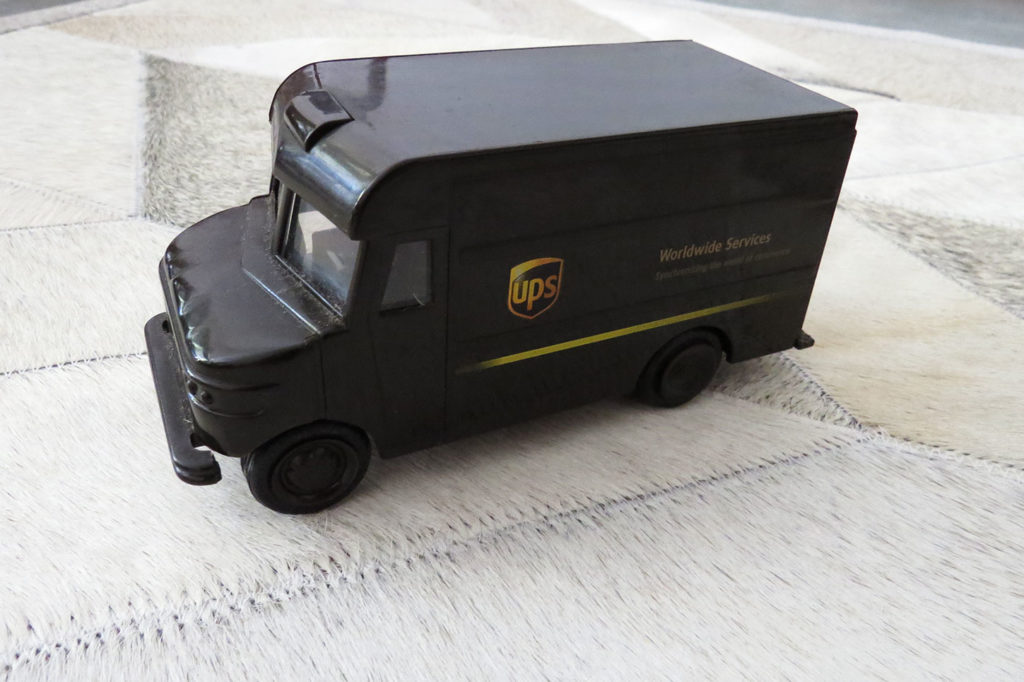 UPS toy truck on Chevron Gray Patchwork Cowhide Rug by Shine Rugs