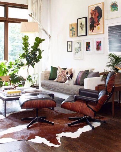 A brown cowhide with unique white spots, paired with classic furniture, many colors and eclectic wall art.