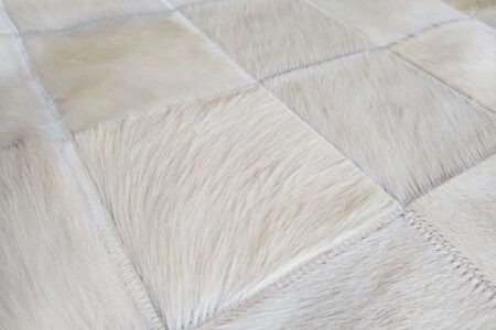 234 Hair on hide detail of cowhide patchwork rug in white squares Hair on hide detail of cowhide patchwork rug in white squares 234