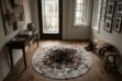 Round Gray and Brown Squares Cowhide Rug on a hardwood floor in a warm, modern home entryway with a dark wood console table.