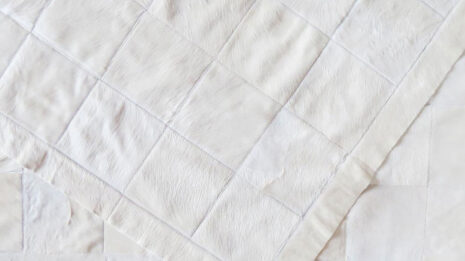 Hair on hide detail of white cowhide patchwork rug in squares