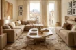 A large Beige Moorish Star Patchwork cowhide rug anchors a bright, luxuriously styled living room. The intricate geometric beige and brown rug sits beneath a raw stone coffee table, flanked by a modern beige sectional sofa and a textured brown chaise lounge, with tall windows revealing a historic town backdrop in the background.