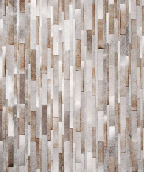 Top view of a taupe striped patchwork cowhide rug
