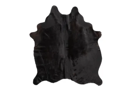 Natural Solid Black Cowhide Rug A top-down view of a natural solid black cowhide rug with irregular, organic edges, laid flat and isolated against a white background.