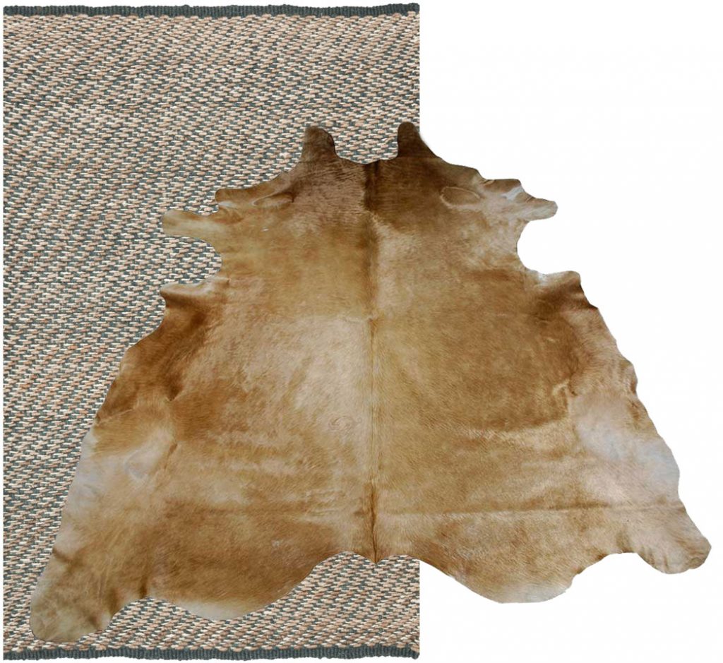 Hand-tufted natural fiber area rug topped with a shiny cowhide rug