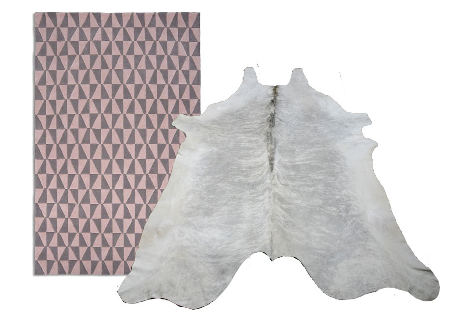 Geometric wooven rug in gray and soft pink together with a light cowhide rug