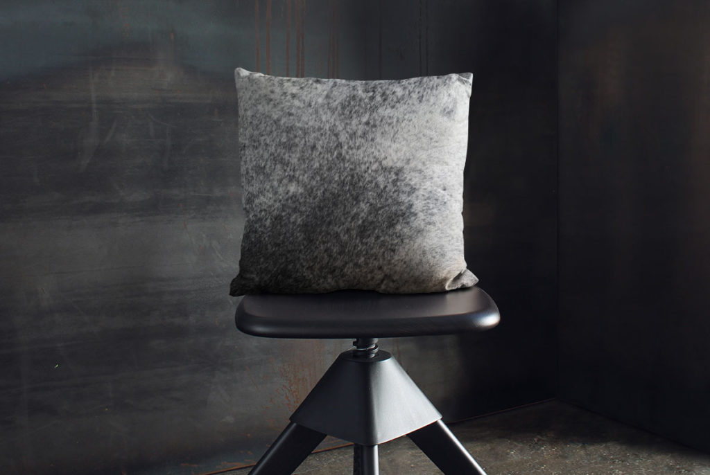 Salt and Pepper Cowhide Throw Pillow on industrial wooden stool