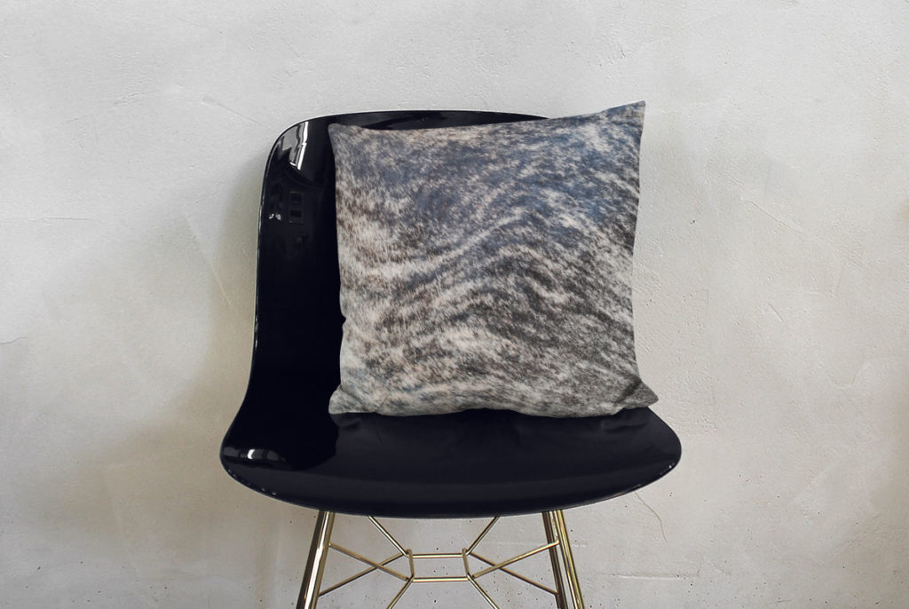 Dark Brindle Cowhide Decorative Pillow on modern black chair
