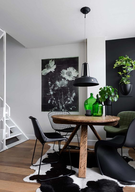 Black and white cowhide area rug in a small dining room