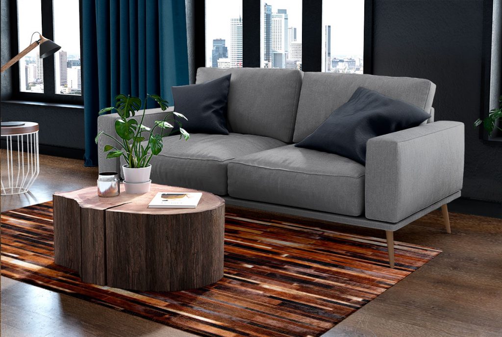 Brown patchwork cowhide rug designed in stripes in a sunny living room