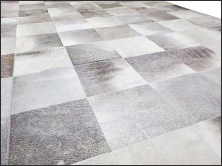 Gray and white patchwork cowhide rug in squares