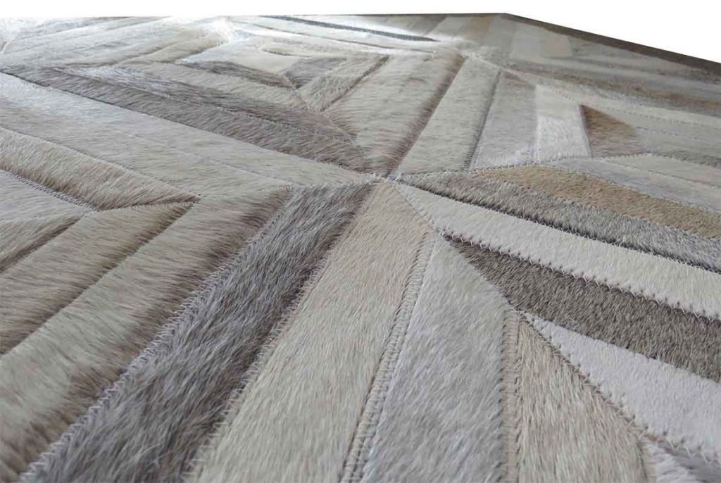 Taupe and cream patchwork cowhide rug in diamond pattern