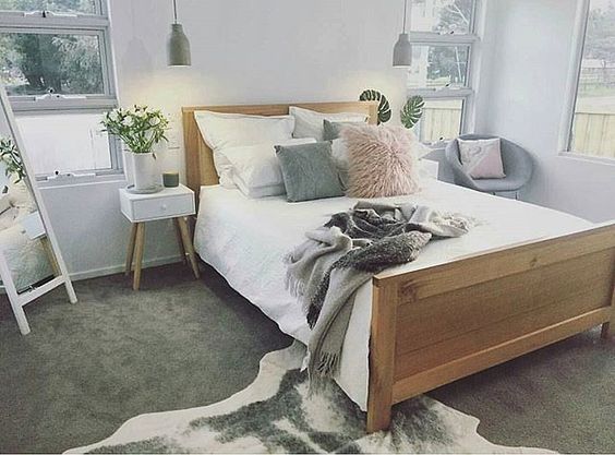Gray cowhide rug in a neutral and blush bedroom