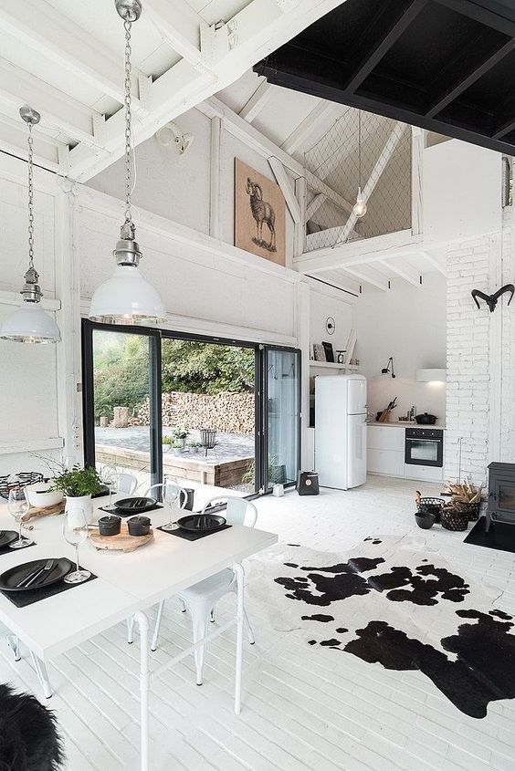 Black and white cowhide area rug in an open plan living room