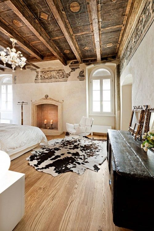 Impressive massive bedroom with black and white cowhide area rug