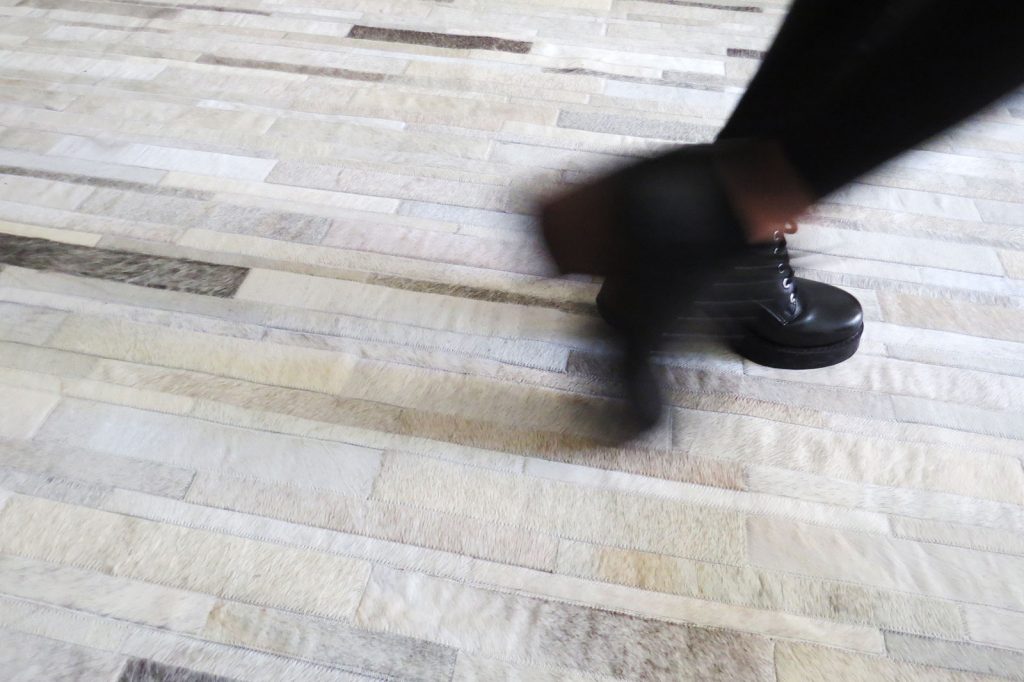 Feet moving on White and Gray Patchwork Cowhide Rug Stripes