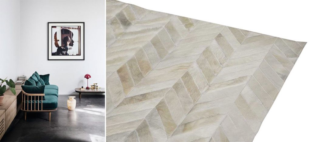 Photo of a concrete floor living room with a white chevron patchwork cowhide rug