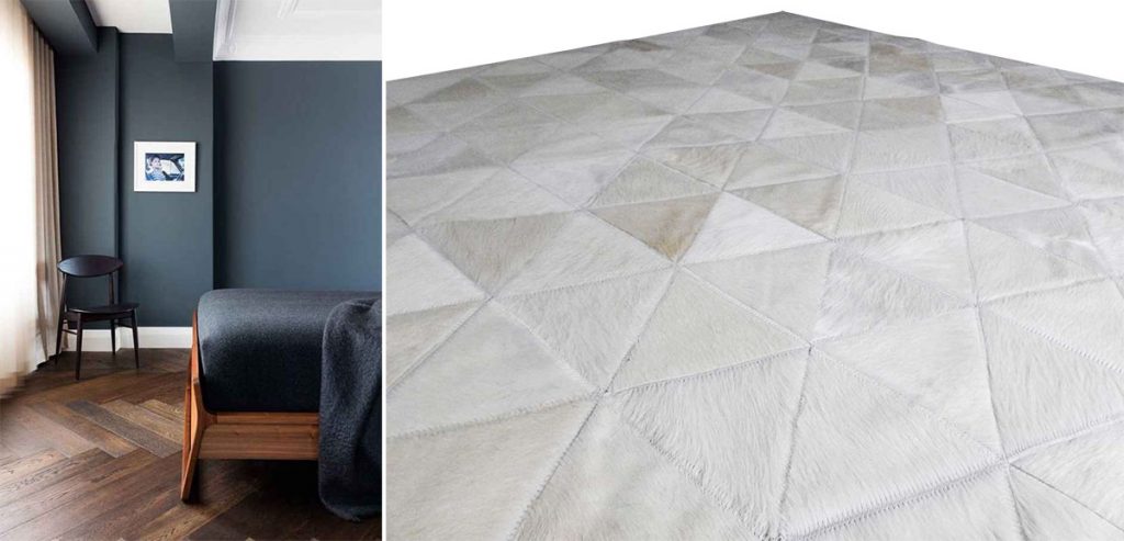 White triangles patchwork cowhide rug and a dark bedroom with herringbone wooden floors