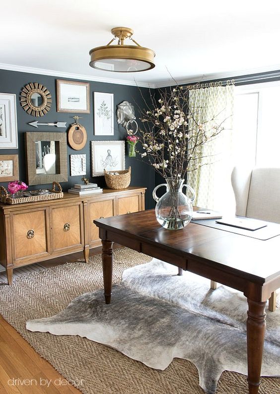 Dark walls, fresh flowers and natural fabrics for this elegant home office with a gray cowhide rug