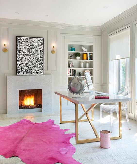 Hot pink cowhide area rug in a cool home office