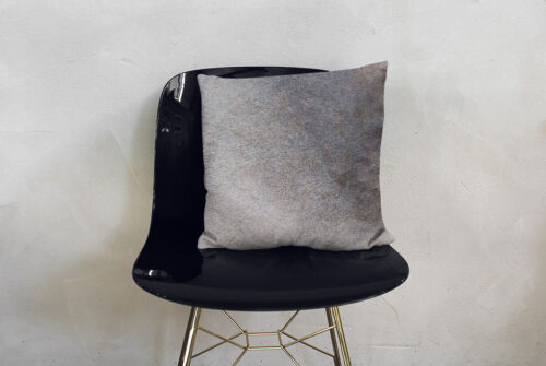 Unique Taupe Gray Cowhide Throw Pillow on Black Modern Chair