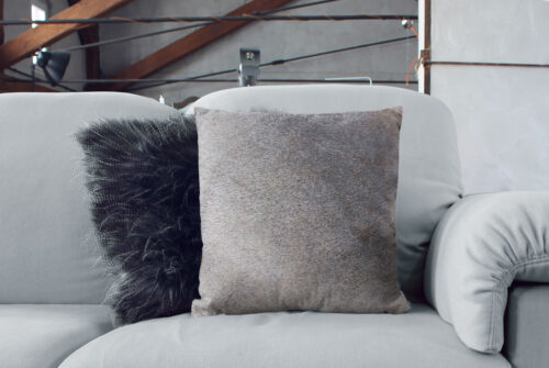 Unique Taupe Gray Cowhide Cushion in living room