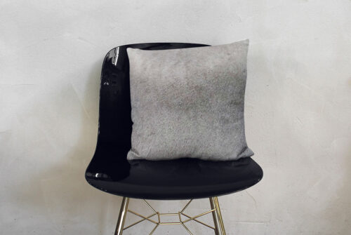 Unique Gradient Gray Cowhide Throw Pillow on Modern Black Chair
