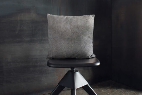 Unique Gradient Gray Cowhide Throw Pillow on Wooden Stool