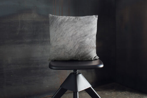 Gray Brindle Pillow on industrial wooden stool