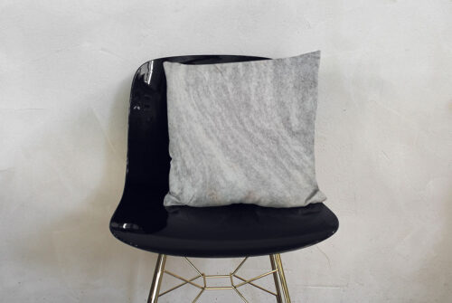 Salt and Pepper Cowhide Throw Pillow on Modern Chair