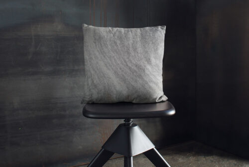 Salt and Pepper Cowhide Pillow on industrial style blackstool