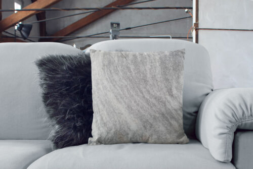 Salt and Pepper Cowhide Pillow on Couch with Scandinavian Cushion
