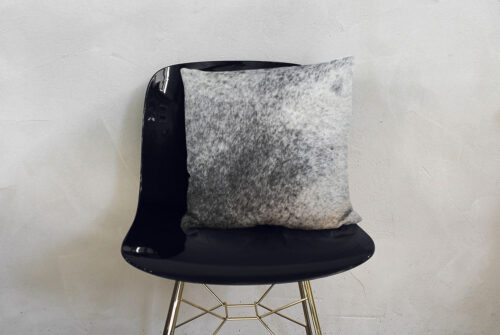 Salt and Pepper Cowhide Throw Pillow and fancy shiny chair