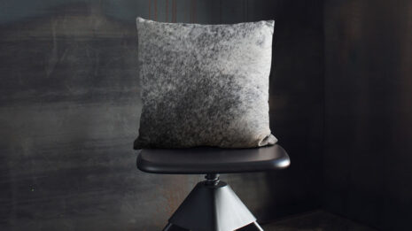 Salt and Pepper Cowhide Throw Pillow on industrial wooden stool