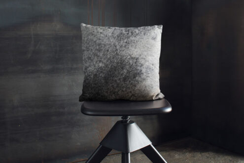 07-saltandpepper-50x50-04 Salt and Pepper Cowhide Throw Pillow on industrial wooden stool