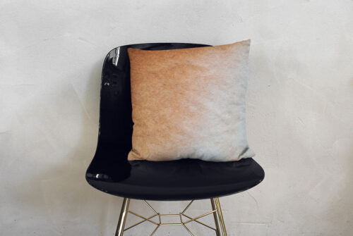 Gradient Soft Beige Pillow on a fancy black chair