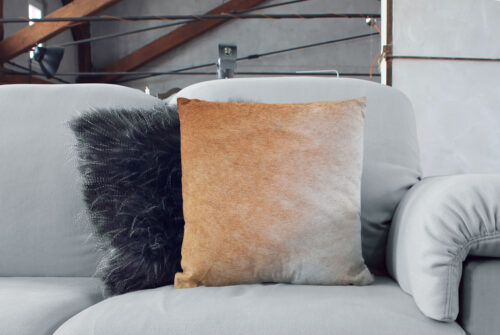 Beige Cowhide Cushion with a soft gradient together with a scandinavian style decorative pillow