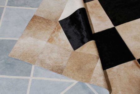 143+++++ detail of a beige and black cowhide patchwork rug in Squares