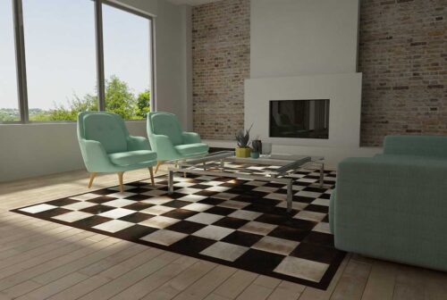 Gray and chocolate brown cowhide patchwork rug in squares with a hair border in sunny living room
