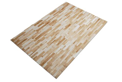 Beige and white patchwork cowhide rug designed in stripes