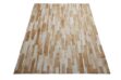Beige and white patchwork cowhide rug designed in stripes