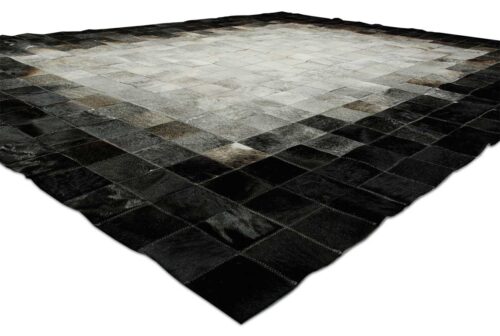 White, gray and black patchwork cow hide rug in squares