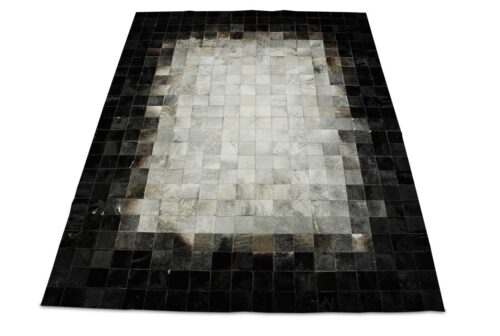 White, gray and black patchwork cowhide rug in squares