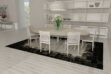 White, gray and black patchwork cowhide rug in dining room