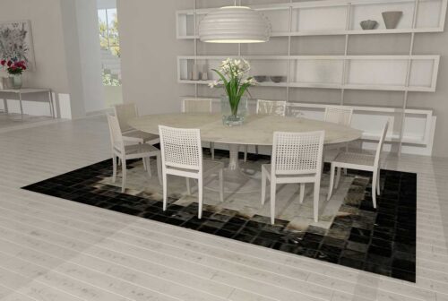 White, gray and black patchwork cowhide rug in dining room